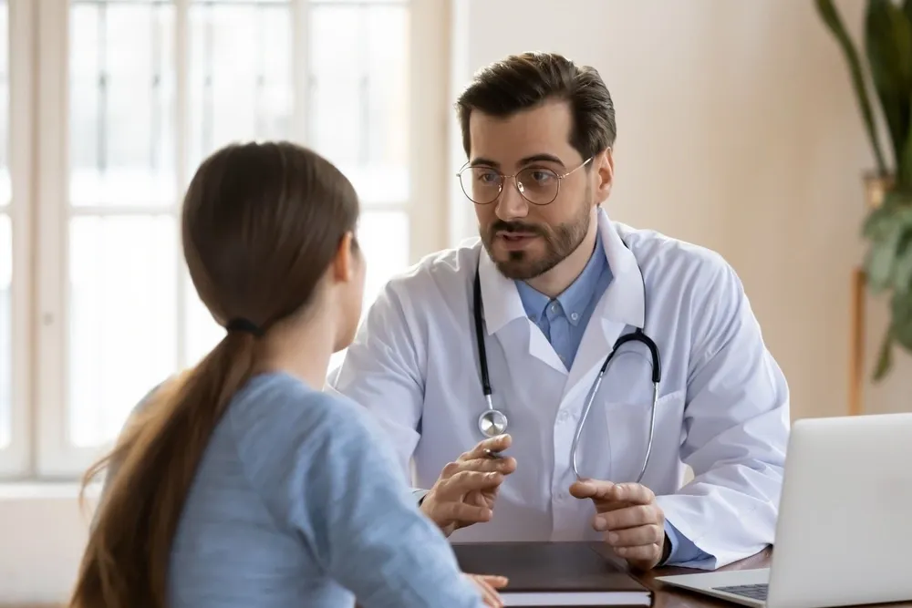 A doctor in Texas converses with a patient, clarifying the complexities of responsibility in medical malpractice cases