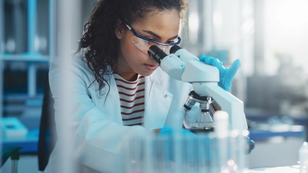 A lab medical technician scrutinizes medical equipment, representing the critical issue of defects as a cause of medical malpractice
