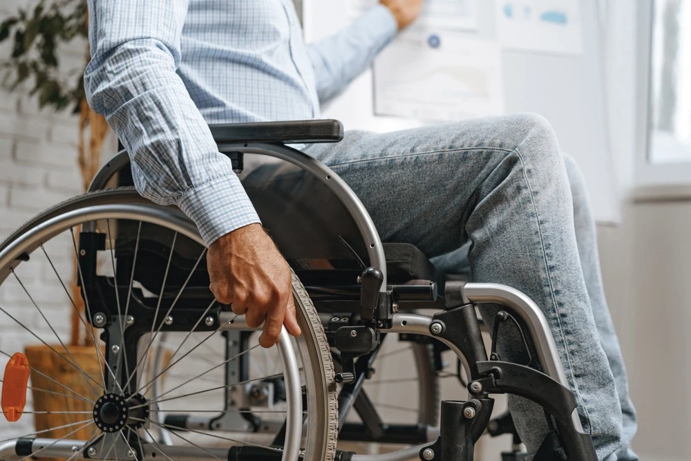 A person in a wheelchair embodies the struggle for justice in a medical malpractice claim, questioning who is responsible for the damage endured